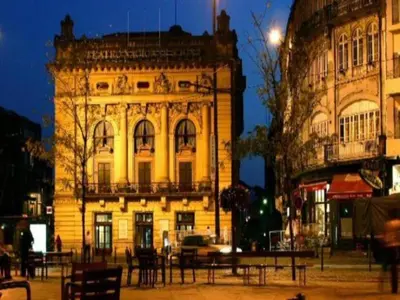an old building with a table in front of it at Central City Escape with Balcony in Porto