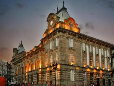 a large building with a clock tower on top of it at 1-bedroom apartment in Porto's heart in Porto