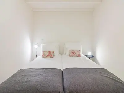 a bedroom with a large bed with two pillows at 1-bedroom apartment in Porto's heart in Porto