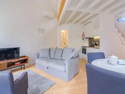 a living room with a couch and a table at Spacious 2-Bedroom Retreat in Porto in Porto