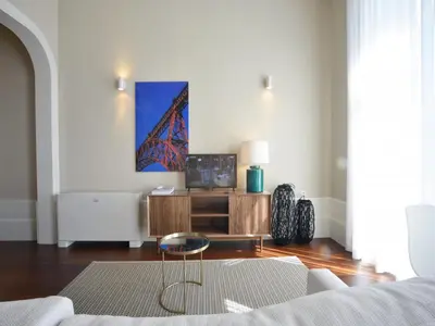 a living room with a couch and a table at Charming Central Porto Apartment in Porto
