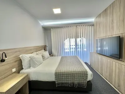 a hotel room with a bed and a television at Charming Modern Studio in Porto in Porto