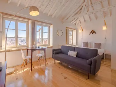 a living room with a couch and a table at Cozy Porto studio perfect location & comfort in Porto
