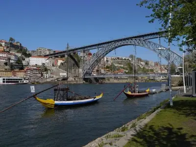 two boats are in the water under a bridge at Pleasant apartment in Oporto in Porto
