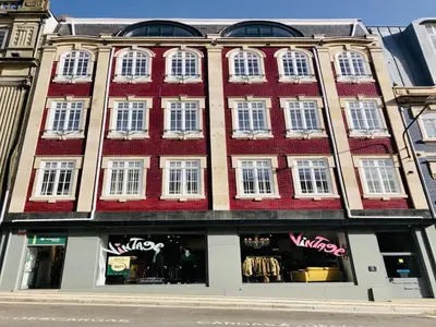 a large building with white windows on a street at Modern apartment in the heart of Porto in Porto