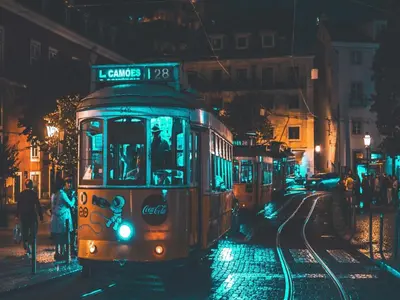 a trolley car on a city street at night at Modern apartment in the heart of Porto in Porto