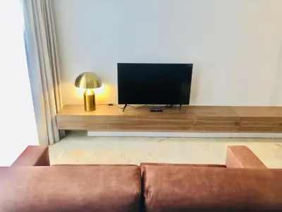 a living room with a couch and a flat screen tv at Bright and Spacious apartment in Porto in Porto