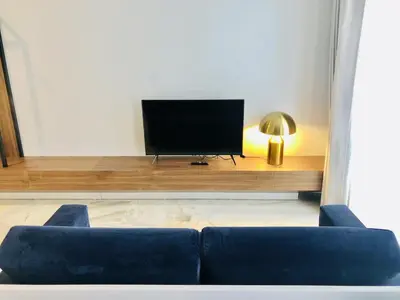 a living room with a couch and a flat screen tv at Bright and Spacious apartment in Porto in Porto
