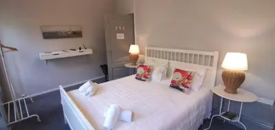 a bedroom with a large white bed with towels on it at Charming House Quental in Porto