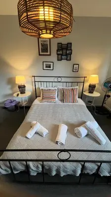 a bedroom with a large bed with two towels on it at Charming House Quental in Porto