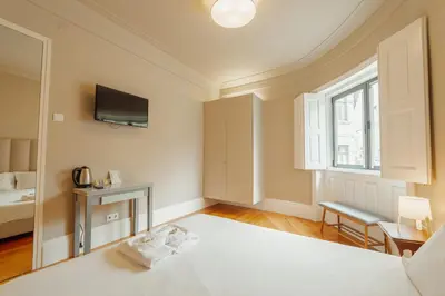 a bedroom with a bed and a window at Boutique Suites by Hosty in Porto