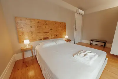 a bedroom with a large white bed with two lamps at Boutique Suites by Hosty in Porto