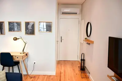 a room with a door and a desk with a lamp at Central and comfortable apartment -downtown in Porto