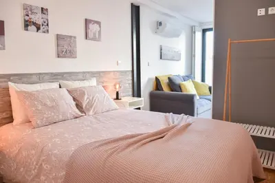 a bedroom with a large bed and a chair at Central with balcony - 9 min-walk to Trindade in Porto