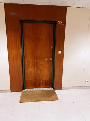 a wooden door in a building with at Downtown Studio 80 meters to metro and Free Parking in Porto