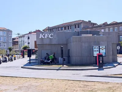 a building with two people sitting outside of it at Downtown Studio 80 meters to metro and Free Parking in Porto