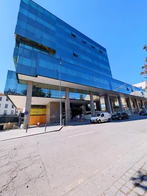 a large glass building with cars parked in front of it at Downtown Studio 80 meters to metro and Free Parking in Porto