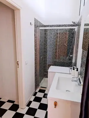 a bathroom with a sink and a shower at Oporto Spacious apartment in Porto