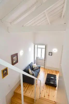 a living room with a couch and a table at Aposentus - Premium Central Apartment 3BR in Porto