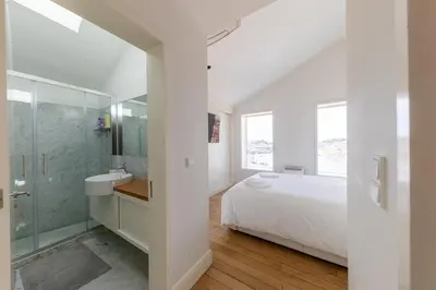 a white bathroom with a bed and a sink and a shower at Casa Vista Douro in Vila Nova de Gaia