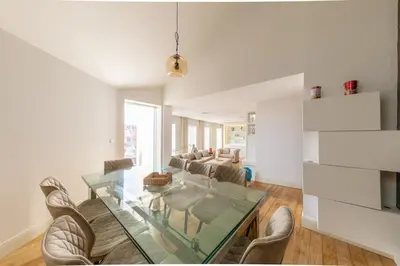 a living room with a glass table and chairs at Casa Vista Douro in Vila Nova de Gaia