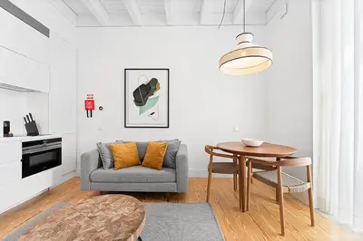 a living room with a table and a couch at GuestReady - D. Hugo Boutique Hotel B&B in Porto