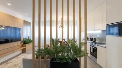 a kitchen with a living room with plants at Bright 2BR Flat near Praça da Galiza by LovelyStay in Porto