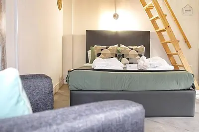 a bedroom with a bed with a ladder next to a ladder at Art Quarter Oporto City Center in Porto