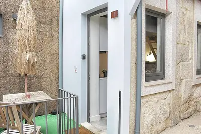 a door of a house with a table and a chair at Art Quarter Oporto City Center in Porto