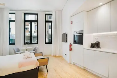 a white room with a bed and a table and chairs at Modern Studio in Porto Center, Ideal City Base in Porto