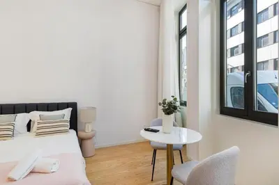 a bedroom with a bed and a table and a chair at Modern Studio in Porto Center, Ideal City Base in Porto