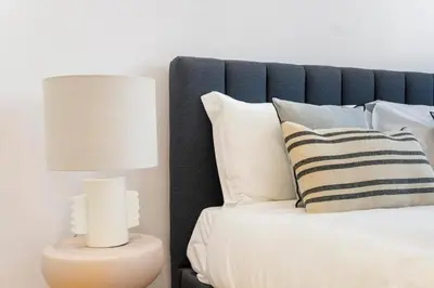a bedroom with a bed with a lamp and pillows at Modern Studio in Porto Center, Ideal City Base in Porto