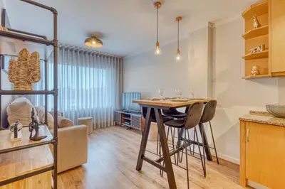 a kitchen with a table and chairs in a room at 700 Verde Esperança in Porto