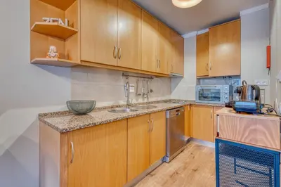a kitchen with wooden cabinets and a sink at 700 Verde Esperança in Porto