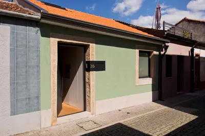 a green and white building with an open door at Gabi's House in Porto
