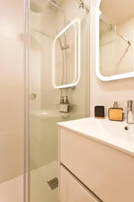 a white bathroom with a shower and a sink at Gabi's House in Porto