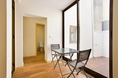 a dining room with a glass table and two chairs at Aposentus - CS Trindade Apartments in Porto