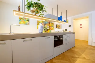 a kitchen with white cabinets and a sink at Discovery Luxury Historic House At Rua das Flores in Porto