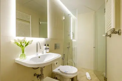 a bathroom with a sink and a toilet and a mirror at Discovery Luxury Historic House At Rua das Flores in Porto