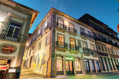 a building with windows and balconies on a street at Discovery Luxury Historic House At Rua das Flores in Porto