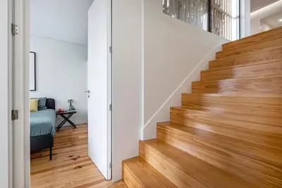 a staircase in a home with white walls and wood floors at Aposentus - Poveiros Terrace View in Porto