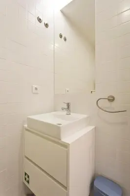a white bathroom with a sink and a mirror at Aposentus - Poveiros Terrace View in Porto