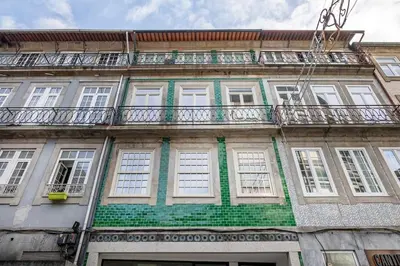 an old building with white and green windows at Aposentus - Poveiros Terrace View in Porto