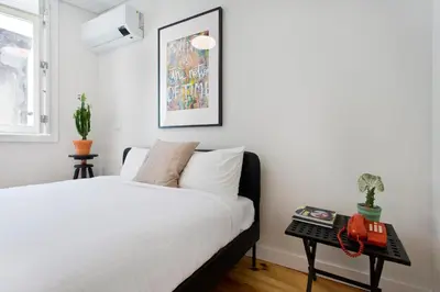 a bedroom with a white bed and a table at Aposentus - Poveiros Terrace View in Porto