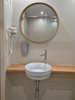 a bathroom with a white sink and a mirror at Sleep Swell in Porto