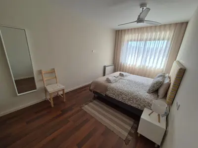 a bedroom with a bed and a mirror and a chair at Sleep Swell in Porto