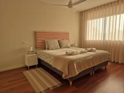 a bedroom with a large bed and a window at Sleep Swell in Porto