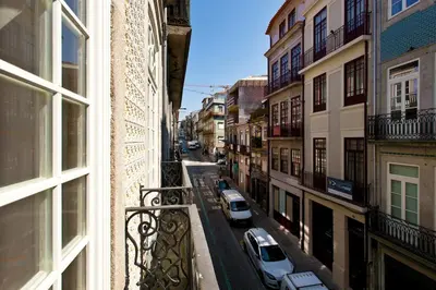 a view of a city street from a balcony at APOSENTUS - Your home in Almada in Porto
