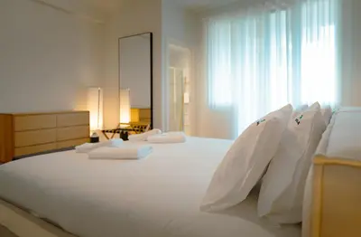 a bedroom with a large white bed with white pillows at The Cale - Porto, Firmeza 1 in Porto