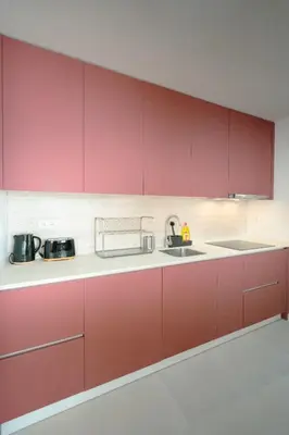 a kitchen with red cabinets and a sink at The Cale - Porto, Firmeza 1 in Porto